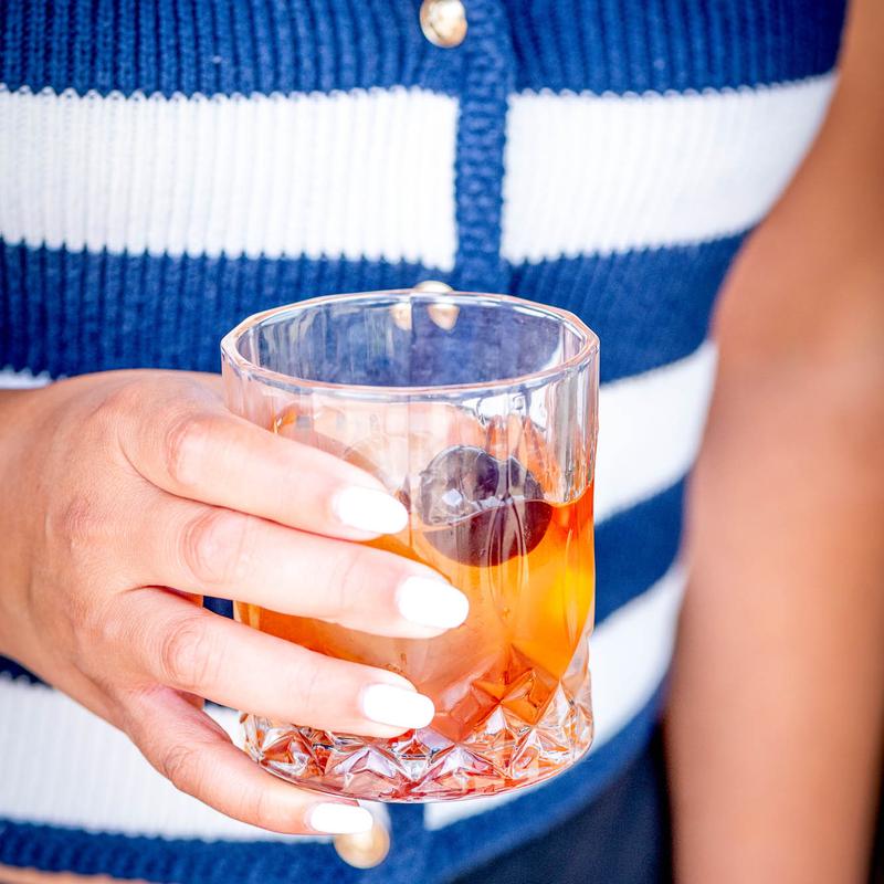 Old-fashioned with cherry on a craft glass